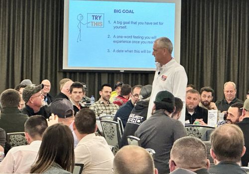 Kyle Pertuis walking amongst attendess while Leading Inspired Action Leadership Live